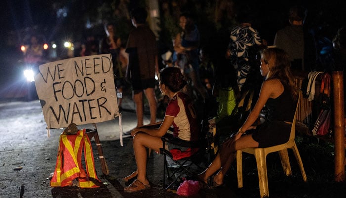 Residents affected by the magnitude-6.9 earthquake sit and wait at the roadside for help in Bogo, Cebu, Philippines, October 2, 2025.— Reuters
