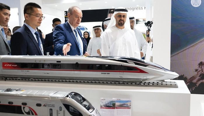 Officials inspect a model train. — Abu Dhabi Media