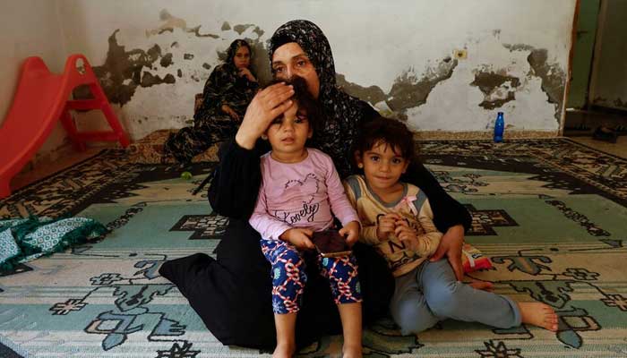 Palestinian woman Samah Abu Latifa, who fled her home amid Israeli strikes, shelters with her family in a kindergarten, in khan Younis in the southern Gaza Strip, October 10, 2023. — Reuters