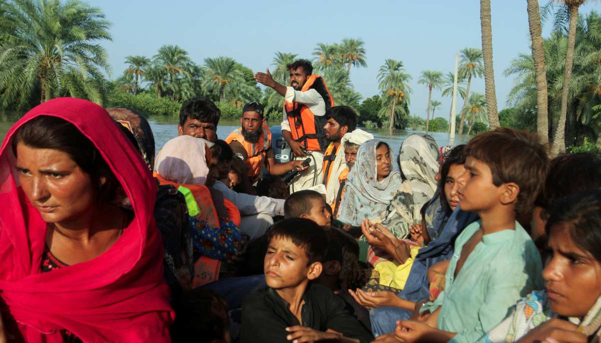 Women and children sit on a rescue boat as they evacuate from the flooded area, following monsoon rains and rising water levels of the Chenab River, in Daryapur village on the outskirts of Jalalpur Pirwala, Punjab on September 9, 2025. — Reuters