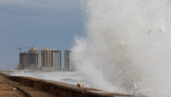 View of residential buildings as the rising waves splash, before the arrival of the cyclonic storm, Biparjoy, over the Arabian Sea, at Clifton Beach, in Karachi, June 13, 2023. — Reuters