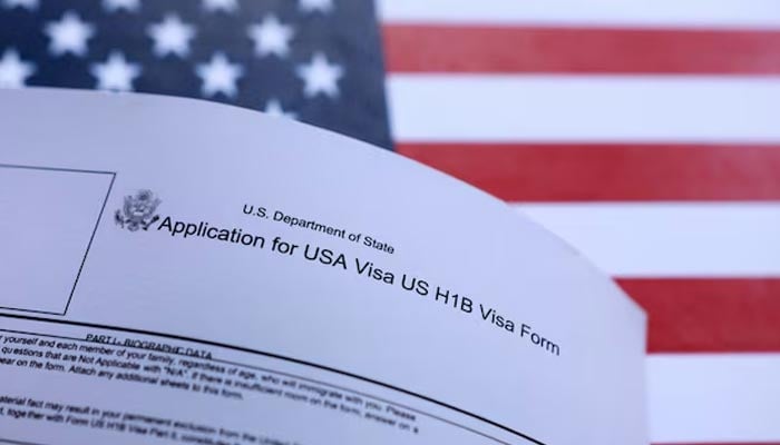 US flag and H-1B Visa application form are seen in this illustration taken September 26, 2025. — Reuters