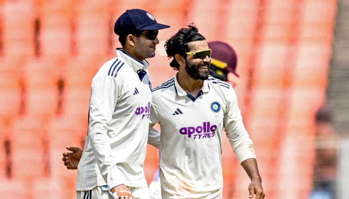 Indias Ravindra Jadeja (Right) celebrates with captain Shubman Gill after taking the wicket of West Indies Johann Layne during the third day of the first Test cricket match between India and West Indies at the Narendra Modi Stadium in Ahmedabad on October 4, 2025.— AFP