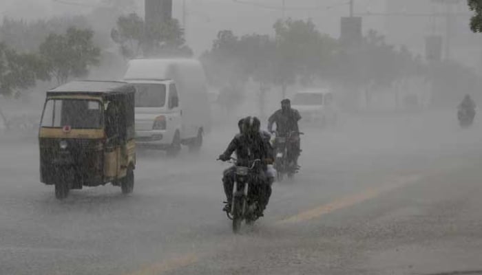 Commuters travel on a road during heavy rain in Karachi on August 20, 2025. — Reuters