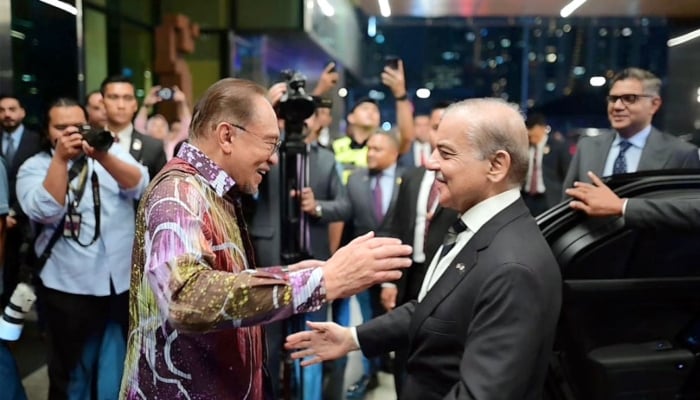 Malaysian Prime Minister Anwar Ibrahim welcomes PM Shehbaz Sharif upon his arrival in the country on October 5, 2025. — Radio Pakistan