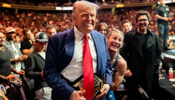 US President Donald Trump poses with a UFC championship belt during an event. — White House website/File