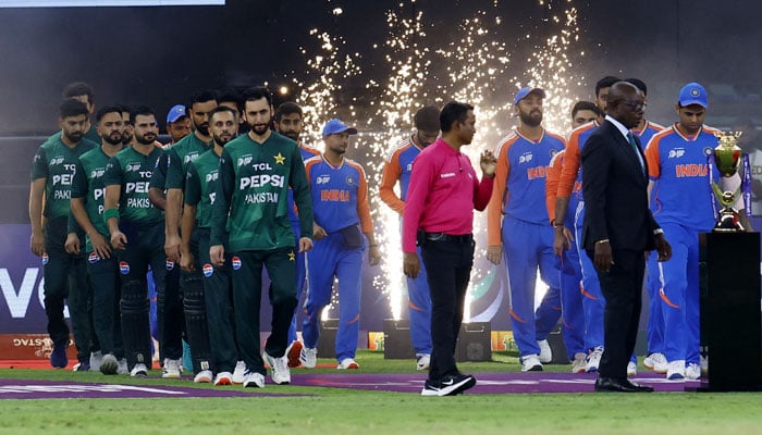 Pakistan and India players walk out before the start of the match in Dubai International Cricket Stadium ahead of start of the match in Dubai International Stadium, United Arab Emirates on September 28, 2025.— Reuters