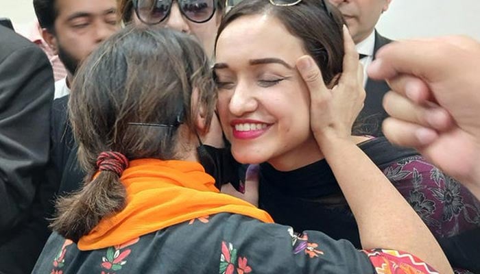 PTI party activist Sanam Javed meets fellow members during her brief release in Islamabad on July 14, 2024.— X/@seemabiatahir