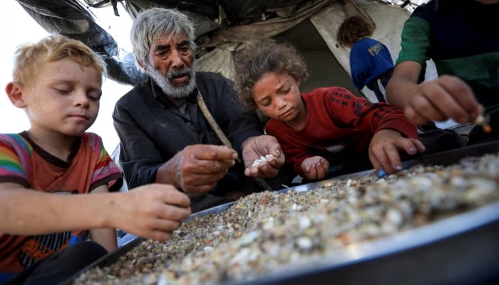 Displaced Palestinians who have not received humanitarian aid gather as they survive on leftover food, amid a hunger crisis, in Gaza, July 28, 2025. — Reuters