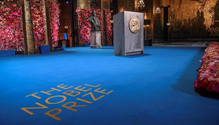 A bust of Alfred Nobel stands next to the podium as preparations are underway before the start of the Nobel Prize ceremony in the Golden Hall of the City Hall of Stockholm on December 10, 2020. — AFP