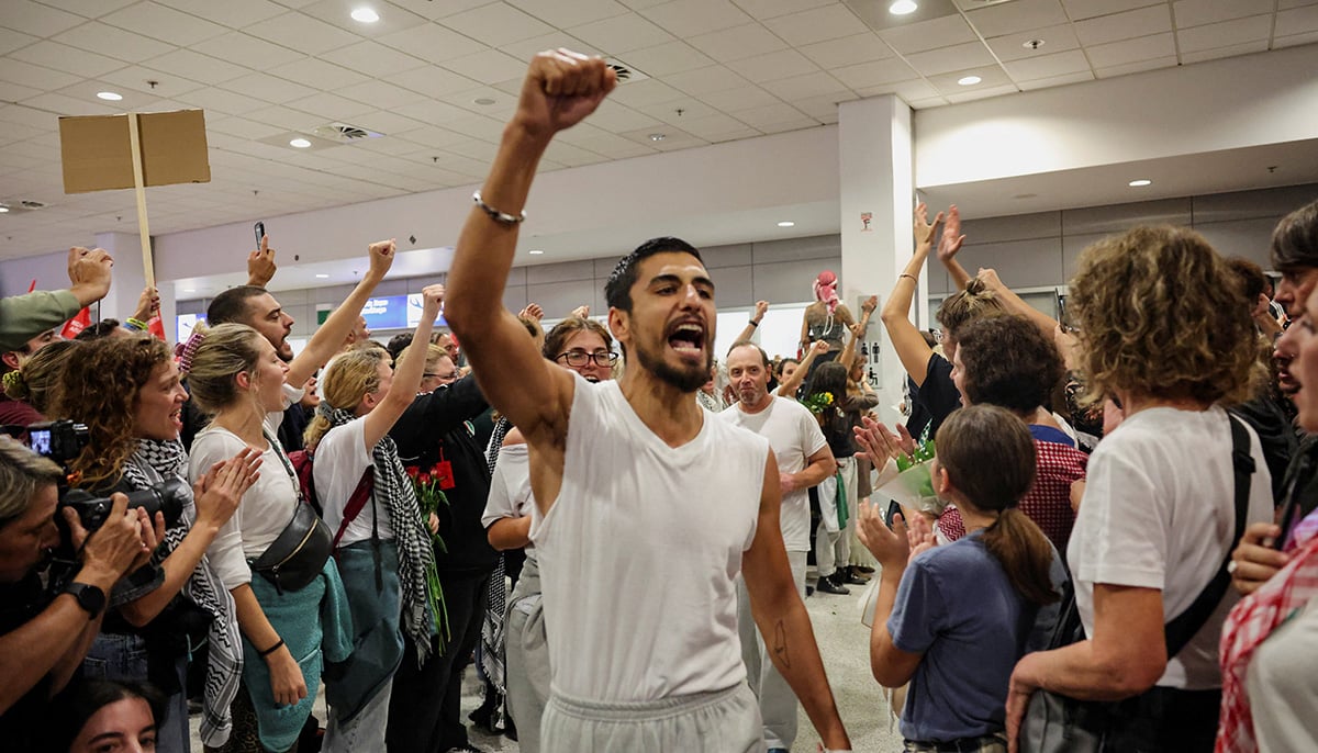 Participants of the Global Sumud Flotilla, who were seeking to deliver aid to Gaza and were detained by Israel, gesture upon their arrival to the Athens Eleftherios Venizelos International Airport, in Athens, Greece, October 6, 2025. — Reuters