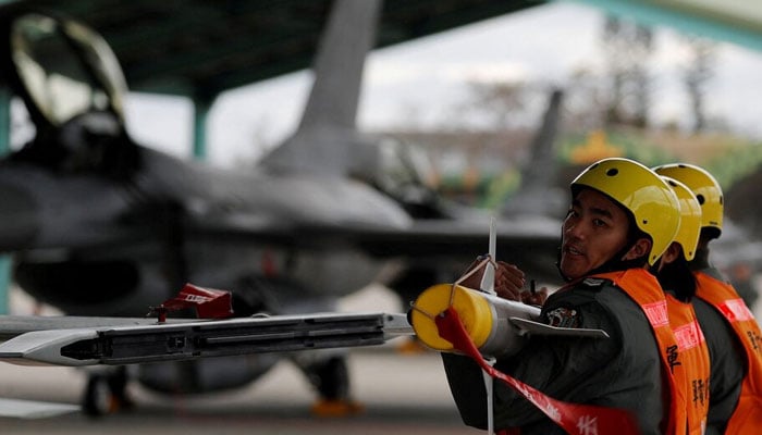 This representative image shows Air force crews lift an AIM-9 Sidewinder air-to-air missiles to be loaded onto Northrop F-5 fighter during a military drill at Zhi-Hang Air Base in Taitung, Taiwan January 30, 2018. — Reuters