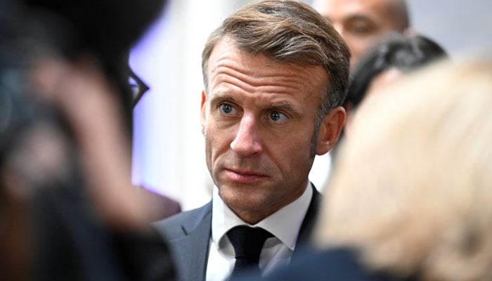 Frances President Emmanuel Macron speaks with guests during a reception as part of the 35th anniversary of German reunification celebrations for the Day of German Unity at the Congresshalle hall in Saarbruecken, Germany, October 3, 2025.— Reuters