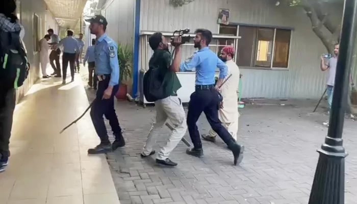 Police personnel assault journalists after storming National Press Club in Islamabad, on October 2, 2025. — Geo News