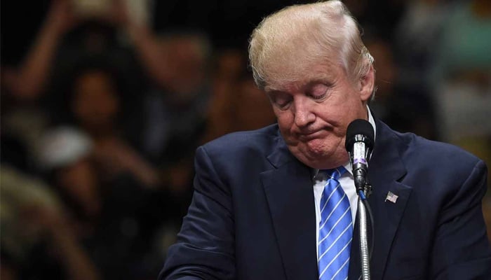US President Donald Trump reacts during a public speech. — AFP