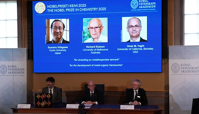 A screen displays the 2025 Nobel Prize laureates in Chemistry, Susumu Kitagawa (Kyoto University, Japan), Richard Robson (University of Melbourne, Australia), and Omar M. Yaghi (University of California, Berkeley, U.S.), as they are announced during a press conference at the Royal Swedish Academy of Sciences in Stockholm, Sweden October 8, 2025. — Reuters