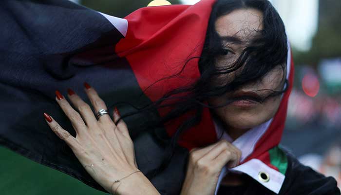 A demonstrator wrapped in Palestinian flag attends protest in Mexico City, Mexico on October 7, 2025. — Reuters