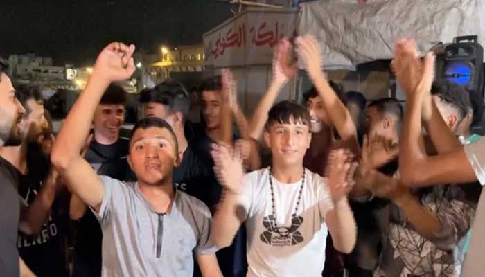 Palestinians celebrate aftrer Israel and Hamas agree to first phase of US President Donald Trumps plan for Gaza, in Khan Younis in the southern Gaza Strip on October 9, 2025. — Reuters