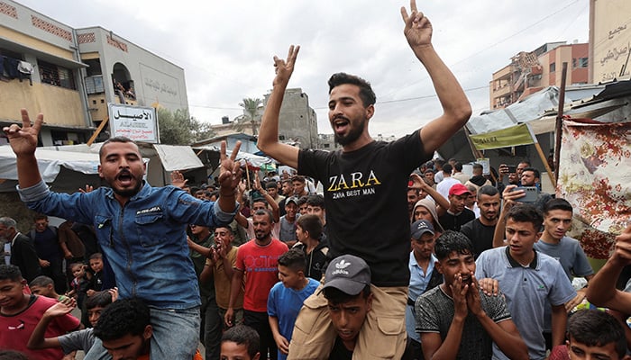 Palestinians celebrate, after U.S. President Donald Trump announced that Israel and Hamas agreed on the first phase of a Gaza ceasefire, in Khan Younis in the southern Gaza Strip October 9, 2025. — Reuters