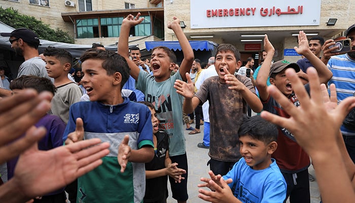 Palestinian children celebrate, after U.S. President Donald Trump announced that Israel and Hamas agreed on the first phase of a Gaza ceasefire, at Al-Aqsa Martyrs Hospital, in Deir al-Balah, in the central Gaza Strip, October 9, 2025. — Reuters