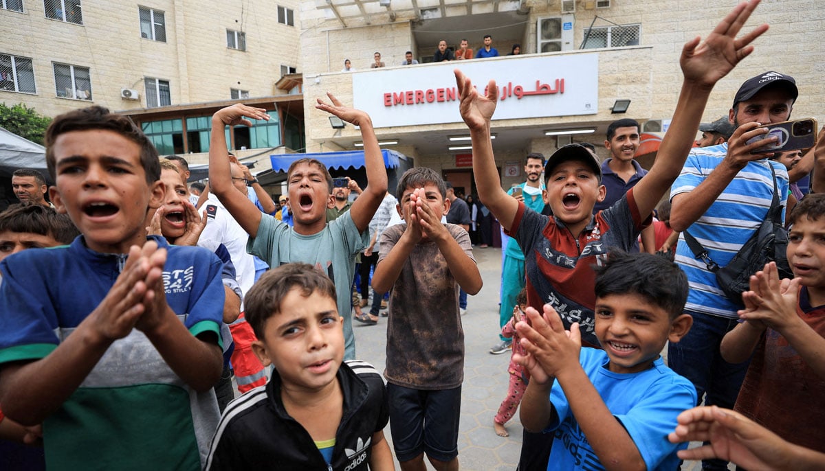 Palestinian children celebrate, after US President Donald Trump announced that Israel and Hamas agreed on the first phase of a Gaza ceasefire, at Al-Aqsa Martyrs Hospital, in Deir al-Balah, in the central Gaza Strip, October 9, 2025. —Reuters