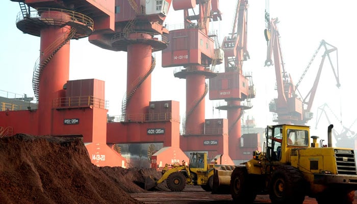 Workers transport soil containing rare earth elements for export at a port in Lianyungang, Jiangsu province, China October 31, 2010.— Reuters