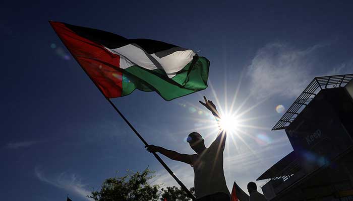 A man waives a Palestinian flag in Cape Town, South Africa, October 9, 2025. — Reuters