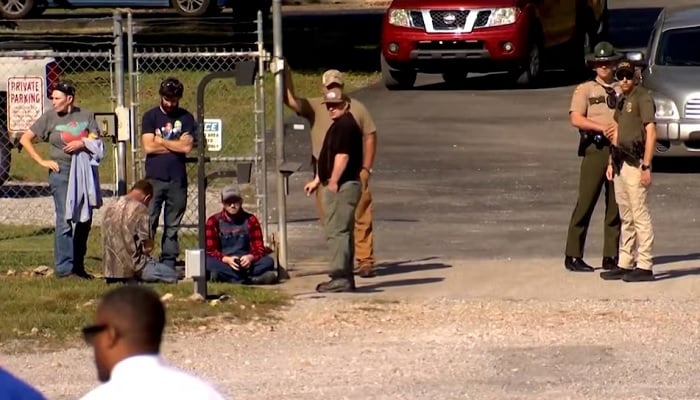 Law enforcement officers guard a gate outside the Accurate Energetic Systems military explosives plant, after an explosion at the facility in Bucksnort, Tennessee, US, October 10, 2025, in a still image from video. — Reuters
