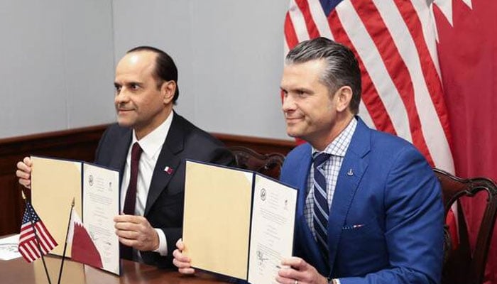 US Defence Secretary Pete Hegseth and Qatari Defence Minister Sheikh Saoud bin Abdulrahman Al Thani sign a letter of acceptance to estsablish a Qatari Emiri Air Force training facility at the Mountain Home Air Force Base in Idaho, at the Pentagon in Arlington, Virginia, on October 10, 2025. — AFP