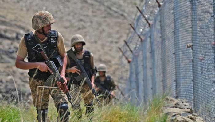 Pakistani troops patrol along Pakistan-Afghanistan border fence at Big Ben post in the Khyber district of the Khyber Pakhtunkhwa province on August 3, 2021. — AFP