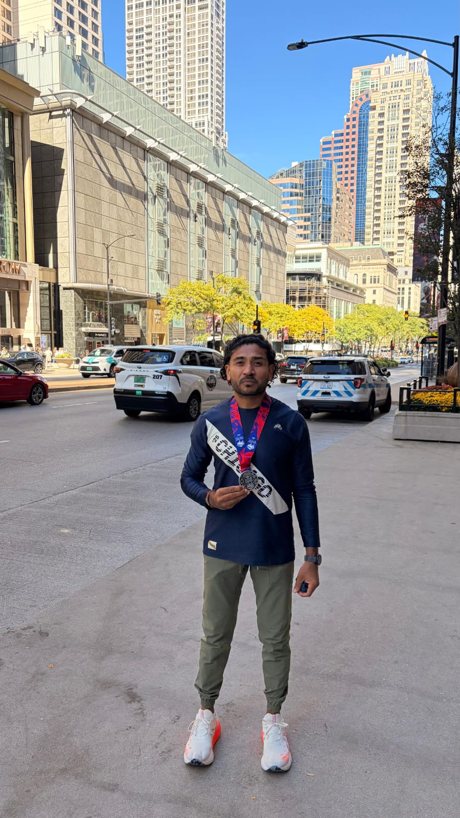 US-Pakistani marathon runner Nizar Nayani displays his medal after finishing the Chicago Marathon. — Reporter