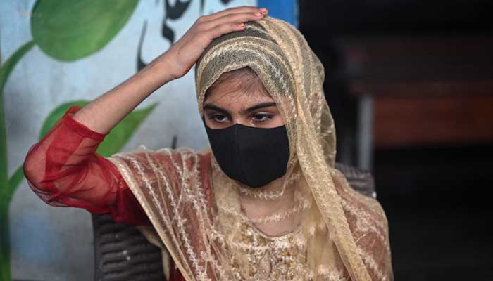 Sania, a household helper, gestures during an interview on July 31, 2025 —AFP