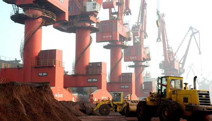 Workers transport soil containing rare earth elements for export at a port in Lianyungang, Jiangsu province, China October 31, 2010. — Reuters