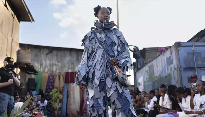 Models show off outfits created by local fashion designers specialising in upcycling discarded fabrics and garments from second-hand clothes markets. — AFP