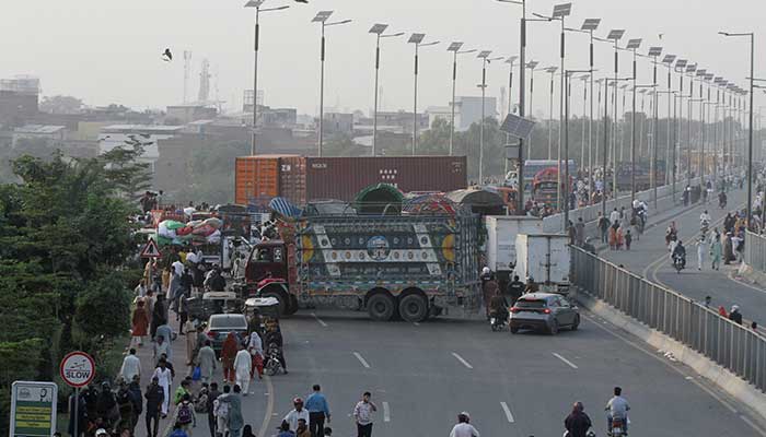 Trucks and containers block Ravi Bridge as supporters of Tehreek-e-Labbaik Pakistan (TLP) supporters march during a solidarity march for Gaza in Lahore, October 10, 2025. — Reuters