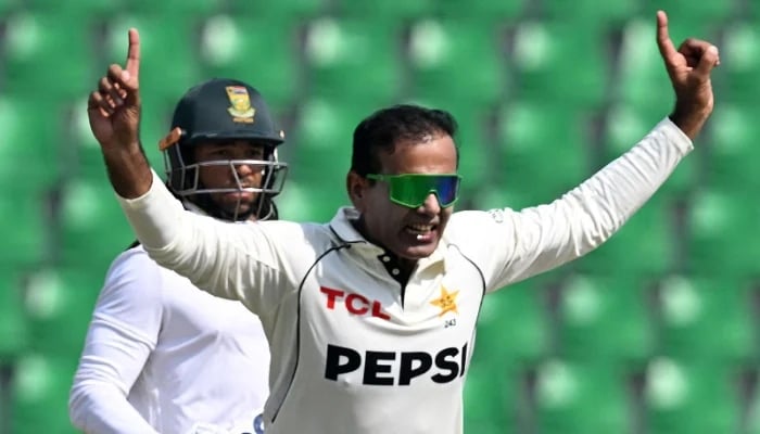 Noman Ali celebrates after taking the wicket of South Africas Tony de Zorzi (L) during the third day of the first Test cricket match between Pakistan and South Africa at the Gaddafi Stadium in Lahore on October 14, 2025. - AFP