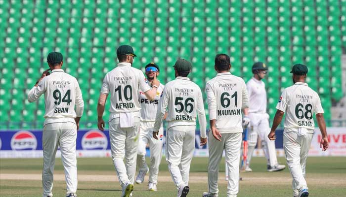 Pakistan players celebrate after getting a wicket against South Africa in a cricket trial match at the Gaddafi stadium in Lahore