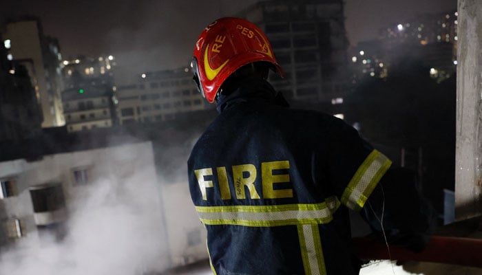 A firefighter sprays water from a multi-storey building to douse the fire that broke out at a garment factory and a chemical warehouse in Dhaka, Bangladesh, October 14, 2025. — Reuters