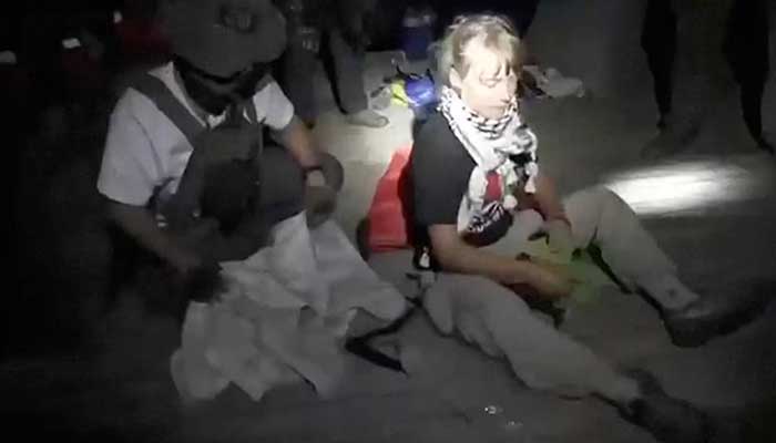 A screengrab from a video shows Swedish activist Greta Thunberg sitting next to a person wearing tactical gear, as vessels of the Global Sumud Flotilla are being intercepted by Israeli security forces, October 1, 2025. — Reuters