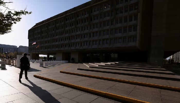 A man casts a shadow as he walks toward the Hubert H. Humphrey Building, headquarters of the Department of Health and Human Services (HHS), in Washington, DC, US, April 1, 2025. — Reuters