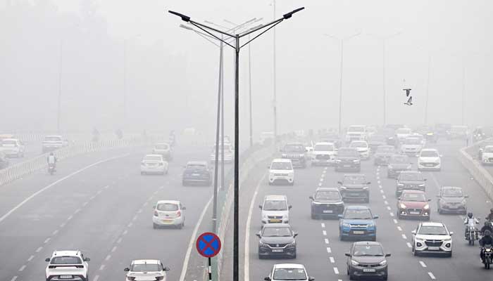 Commuters drive amid dense smog in New Delhi on November 13, 2024. — AFP