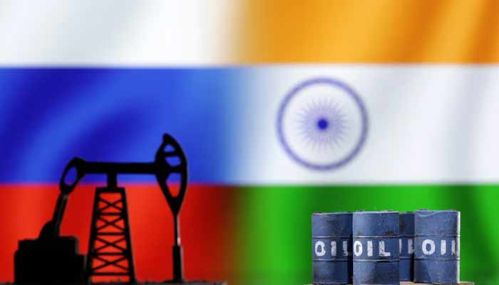 A model of an oil pump jack and oil barrels are seen in front of Russian and Indian flags in this illustration taken, December 9, 2022. — Reuters