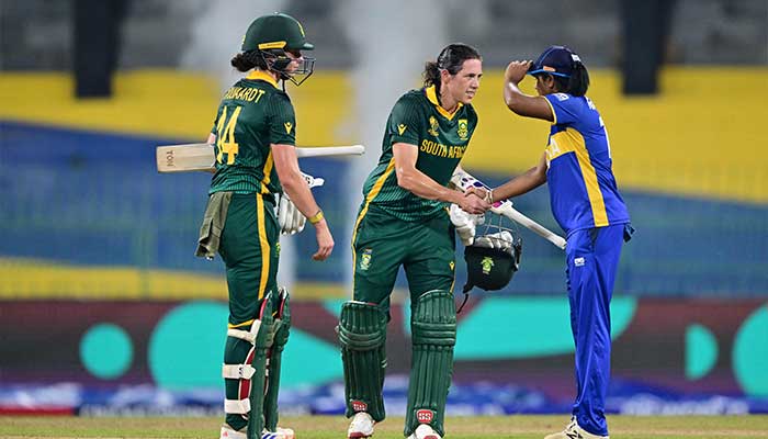 South Africas Laura Wolvaardt (L) and Tazmin Brits (C) shake hands with Sri Lankas Harshitha Samarawickrama (R) after winning the ICC Womens Cricket World Cup 2025 match against Sri Lanka at the R Premadasa International Cricket Stadium in Colombo on October 17, 2025. — AFP