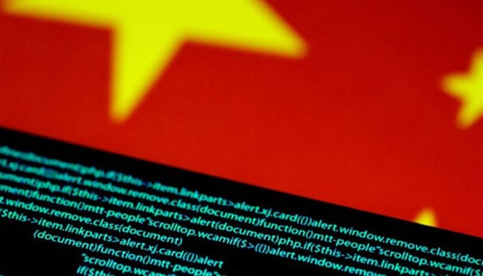 Computer code is seen on a screen above a Chinese flag in this July 12, 2017 illustration photo. — Reuters/File