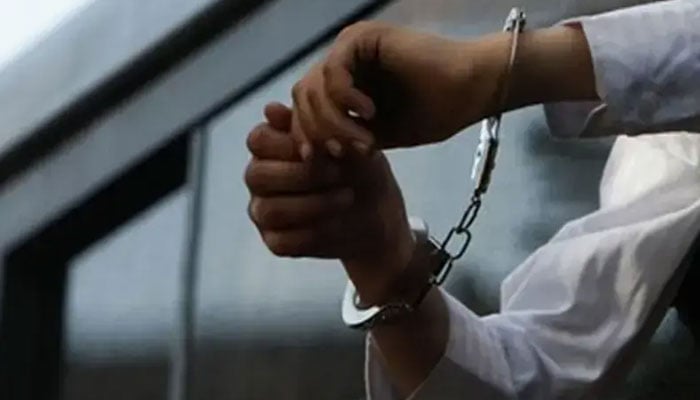 A file photo of a pair of hands in handcuffs. — Reuters/File