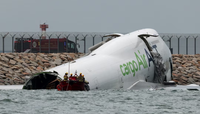 Emergency personnel work near a cargo plane lying partially in the sea after it veered off the runway during landing at Hong Kong International Airport in Hong Kong, China, October 20, 2025. — Reuters