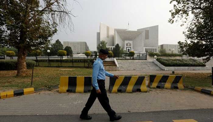 A policeman walks past the Supreme Court building in Islamabad. — Reuters/File