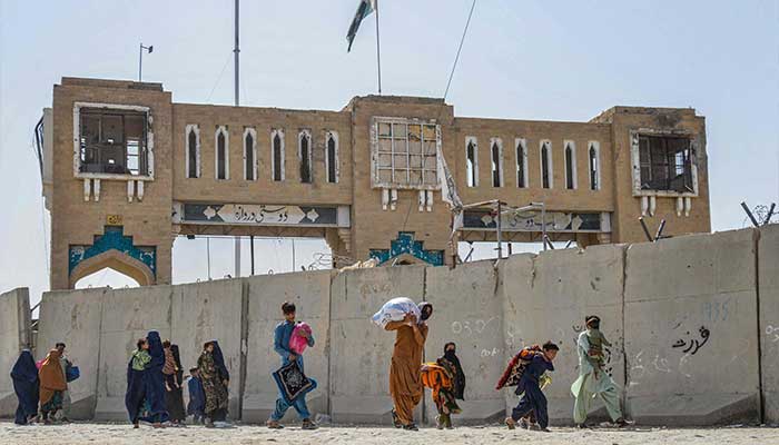 Afghan refugees deported from Pakistan arrive with their belongings at the zero point border crossing between Afghanistan and Pakistan in Spin Boldak district of Kandahar province on October 19, 2025. — AFP