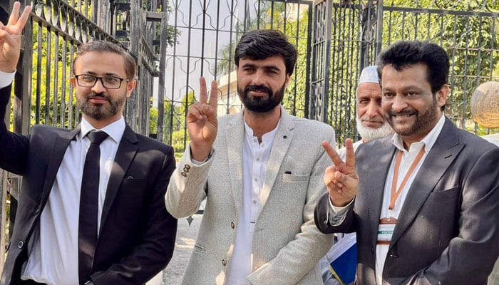 Arshad Khan (centre) and his lawyers flash victory signs outside the Lahore High Court Rawalpindi bench on October 20, 2025. — Arshads team