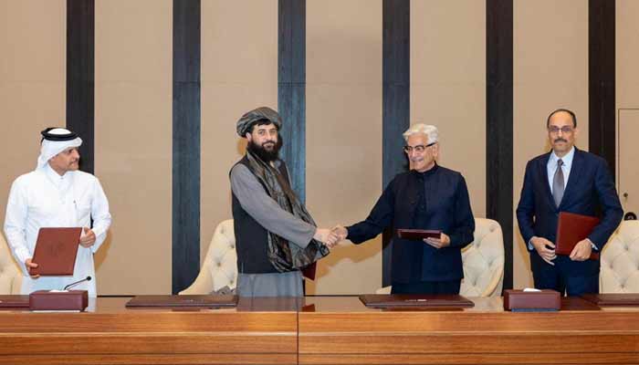 Defence Minister Khawaja Asif shakes hands with his Afghan counterpart Mullah Yaqoob after reaching a ceasefire deal with the Taliban regime in Doha, Qatar, on October 18, 2025. — Reuters